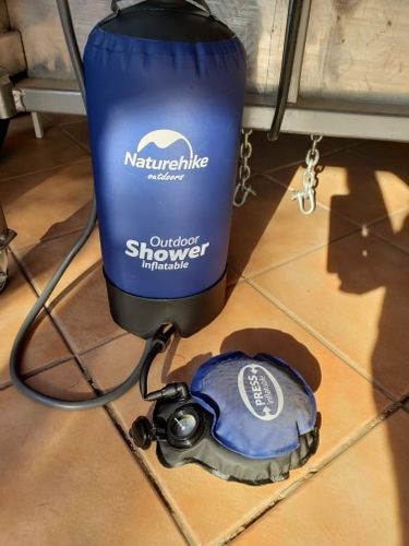 Outdoor camping folding shower bag shown with portable water container design