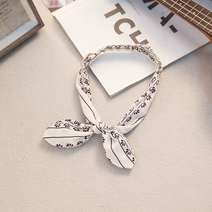 Big bow tie bunny ears headband in a playful design with oversized bow and soft rabbit ears
