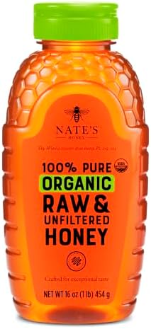 Nate's Organic Honey in a 16oz squeeze bottle, golden honey dripping from the nozzle, natural and pure organic honey product