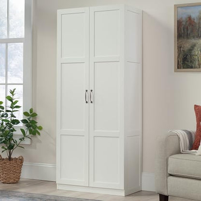 Sauder white storage cabinet with pantry shelves, ideal for organizing snacks and kitchen essentials.