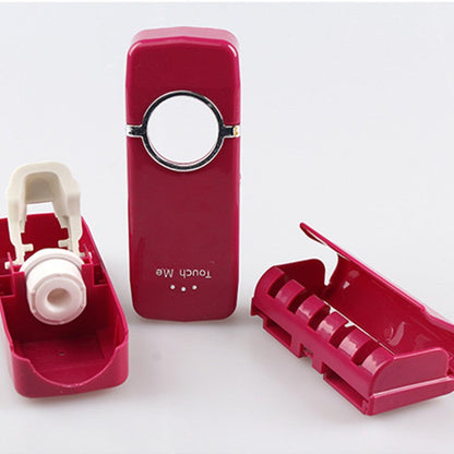 Automatic toothpaste squeezer dispenser mounted on a bathroom wall