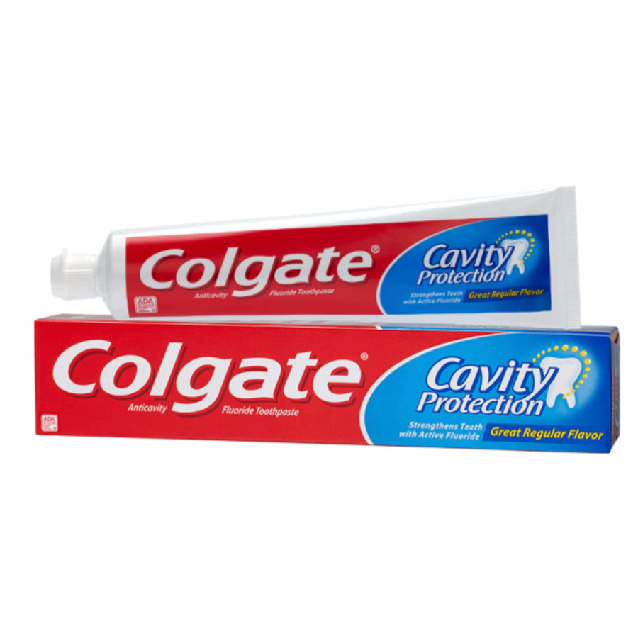 Colgate® cavity protection toothpaste in a white tube with blue and red accents, 8 oz size, on a bathroom counter