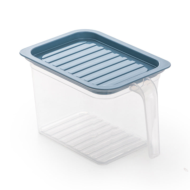 Household refrigerator crisper drawer interior with clear plastic storage compartment
