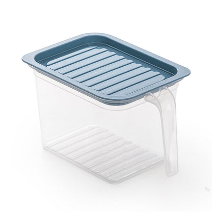 Household refrigerator crisper drawer interior with clear plastic storage compartment