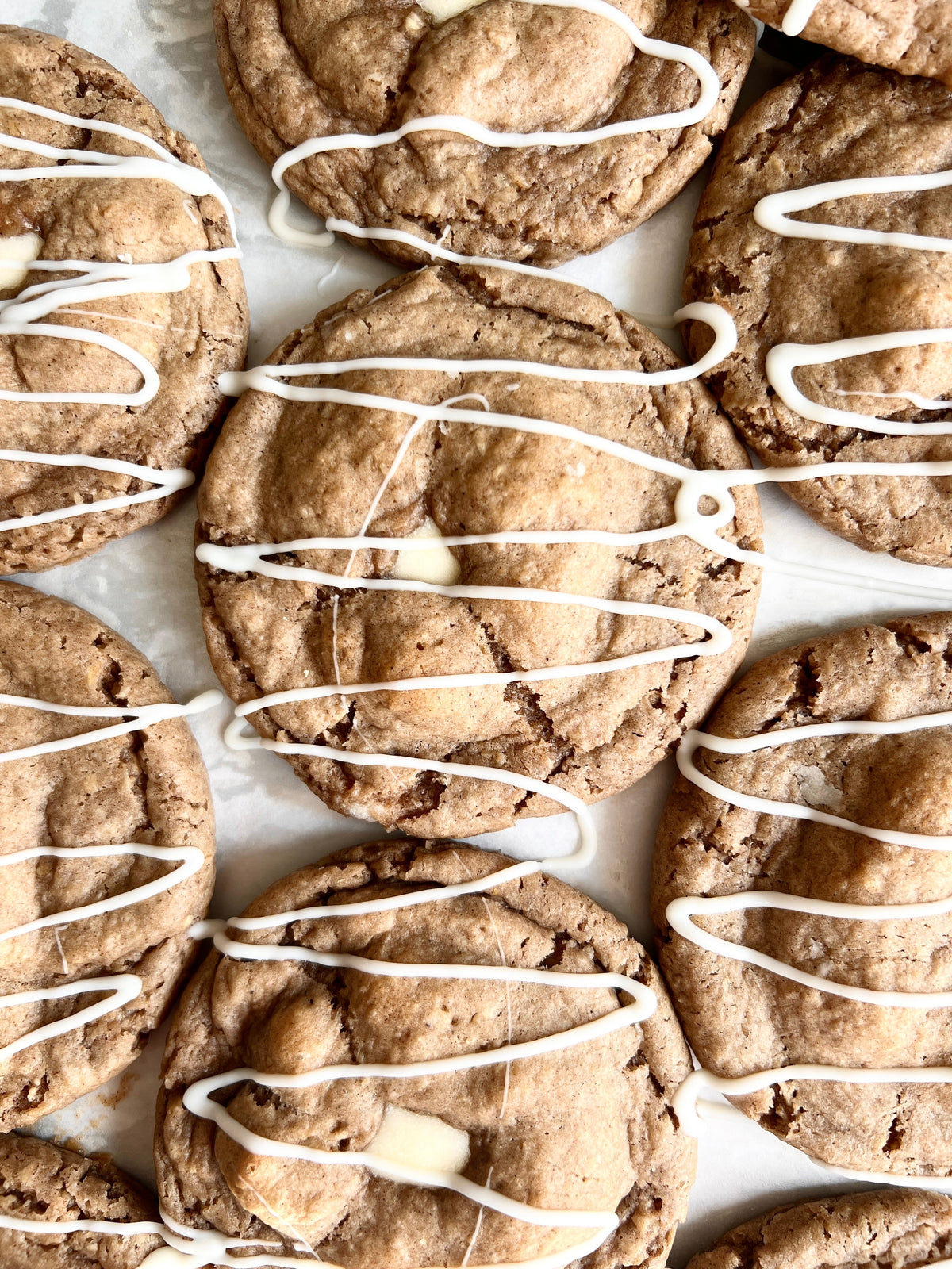 Let's Get Baked Artisan Desserts oatmeal cream pie with creamy filling and soft cookie layers on a white background.
