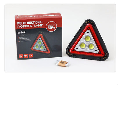 Triangular red warning light displayed on a plain background