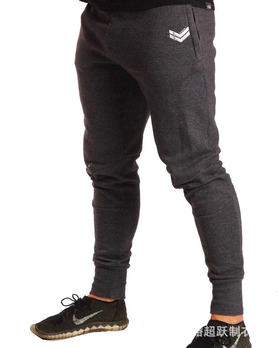 Running training pants in black fabric, side view