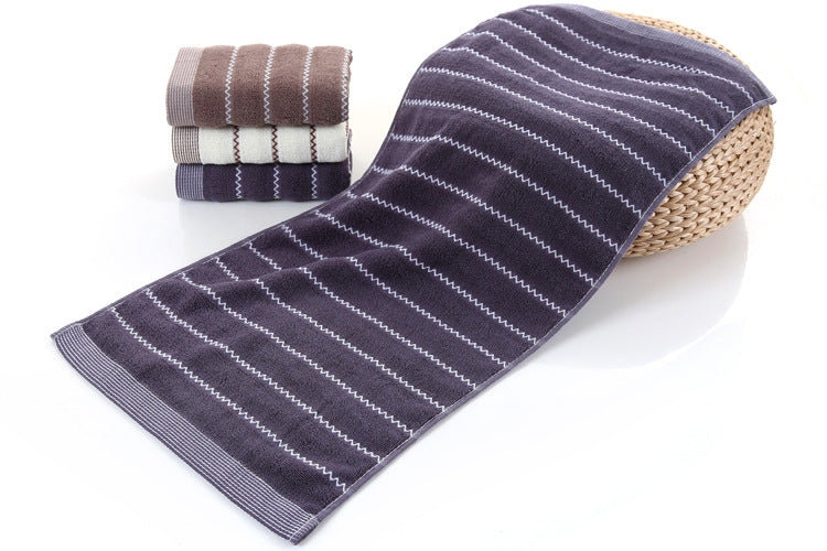 Cotton embroidered towel with detailed stitched design, shown folded neatly