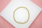 18K gold filled elastic bead bracelet by MIA Jewelry featuring 4mm gold beads and three round CZ charm accents.