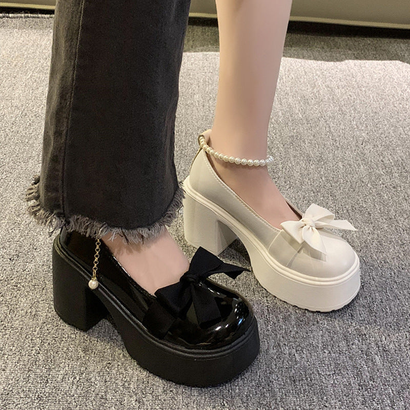 Pearl bow high-heeled leather shoes in a close-up product view