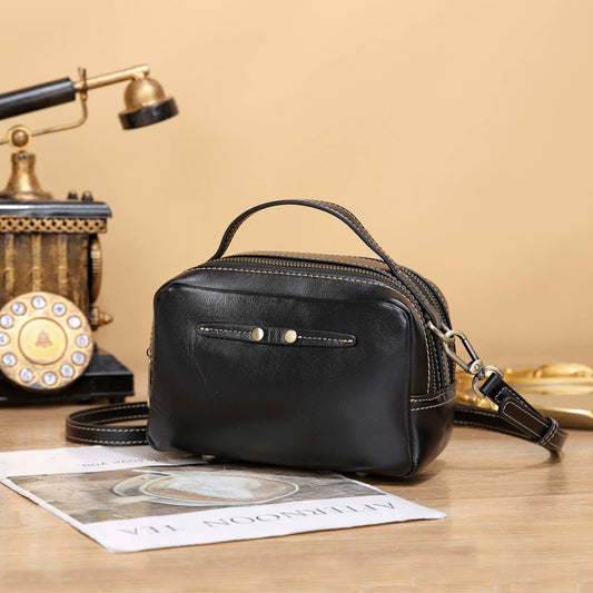 Vintage top-grain cowhide box bag with logo, shoulder strap, and crossbody design for commuting