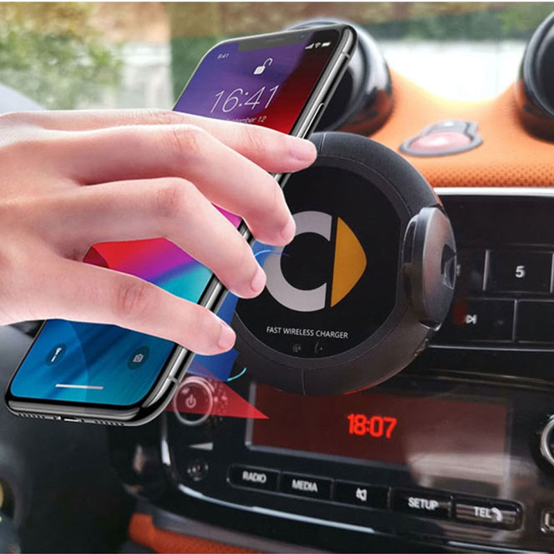 Car wireless charger mounted on a dashboard, featuring a compact design and secure phone holder.