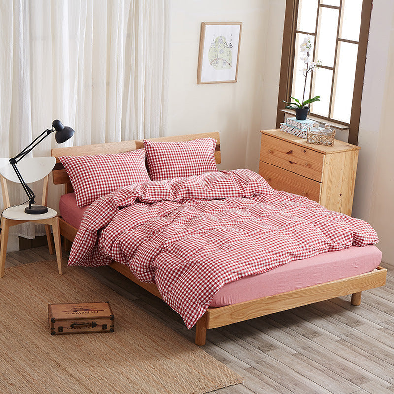 Pure cotton four-piece bed sheet set in white, featuring a fitted sheet, flat sheet, and matching pillowcases