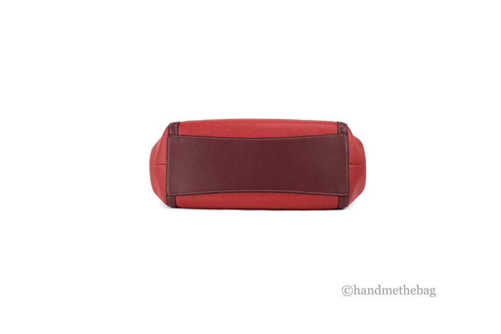 Coach Kristy red apple leather shoulder bag with triple compartments, stylish and spacious for everyday use.
