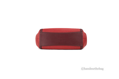 Coach Kristy red apple leather shoulder bag with triple compartments, stylish and spacious for everyday use.