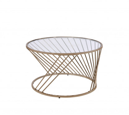 Round coffee table with champagne-tinted glass top, clear glass accents, and metal frame designed for modern living spaces.