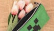 Fabric cartoon stationery bag with colorful character design and zip closure