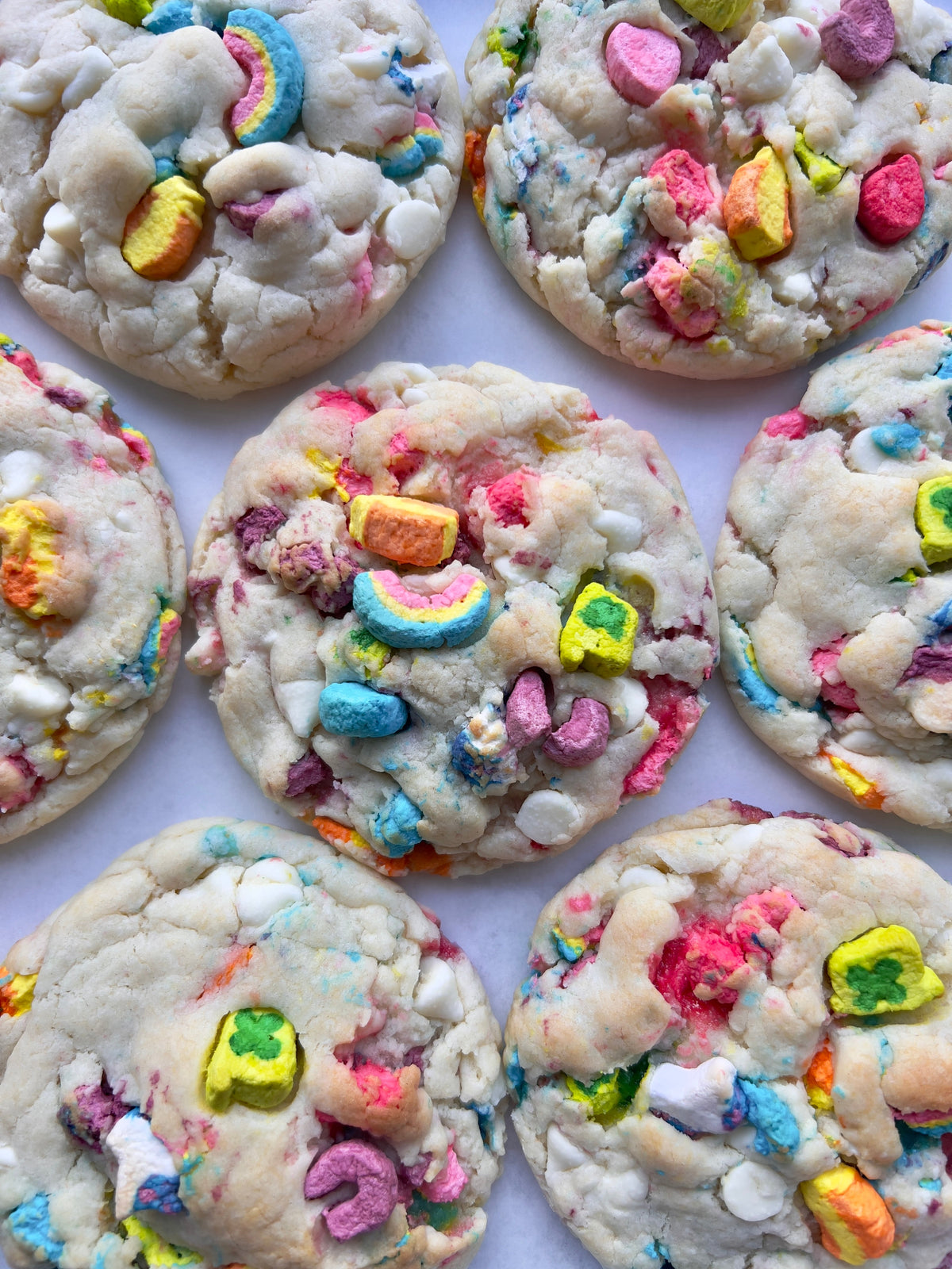 Let's Get Baked Artisan Desserts Lucky Charms cookies with colorful cereal pieces inside on a white background
