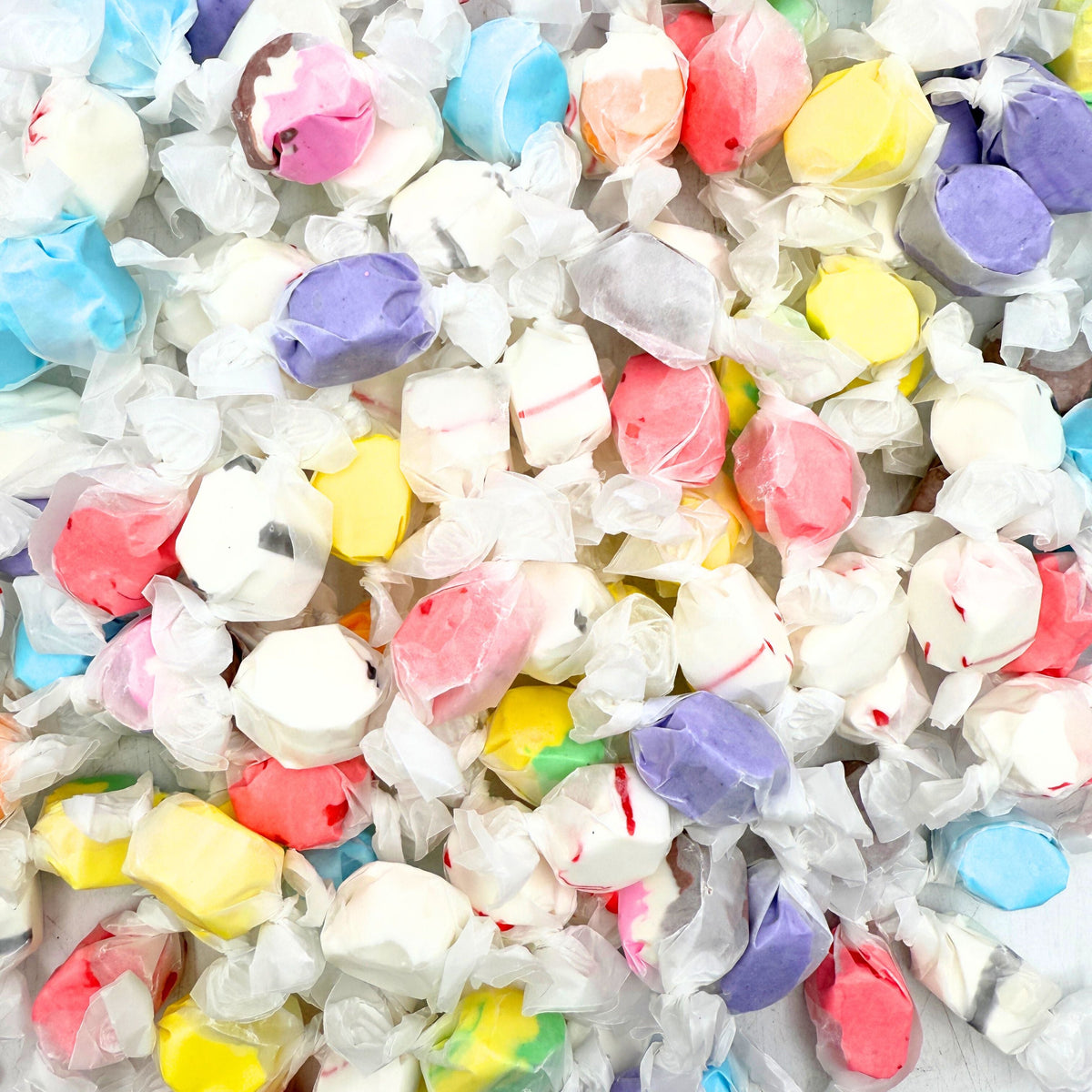 Assorted Salt Water Taffy Candy from Candy In Bulk in a large variety pack, featuring colorful chewy candies in different flavors.