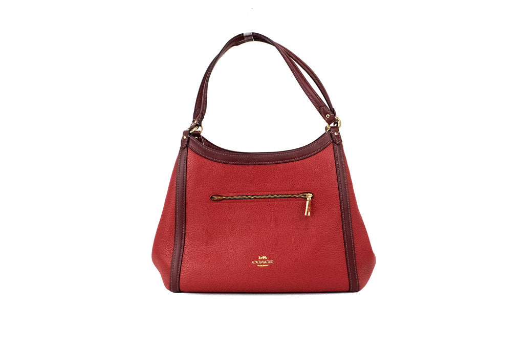 Coach Kristy red apple leather shoulder bag with triple compartments, stylish and spacious for everyday essentials.