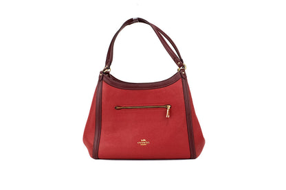 Coach Kristy red apple leather shoulder bag with triple compartments, stylish and spacious for everyday essentials.