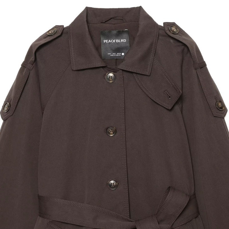 Elegant belted twill-textured trench coat with double-breasted front and structured lapels