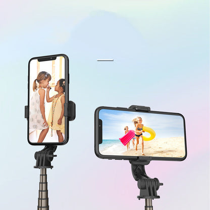 Mini tripod selfie stick phone holder compatible with Apple, shown folded for desktop use