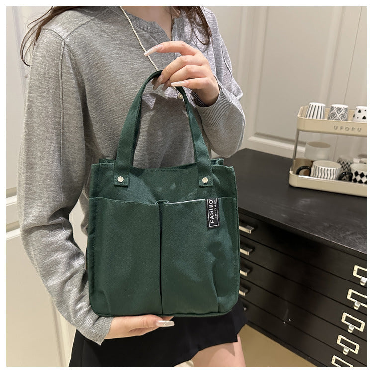 Plain-colored student lunch box tote bag with simple design and sturdy handles