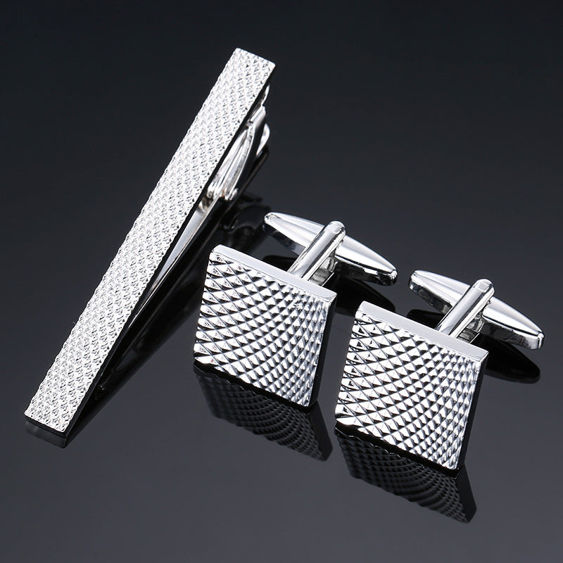 Gold and silver black crystal rose enamel flower tie clip and cuff buckle set, close-up view