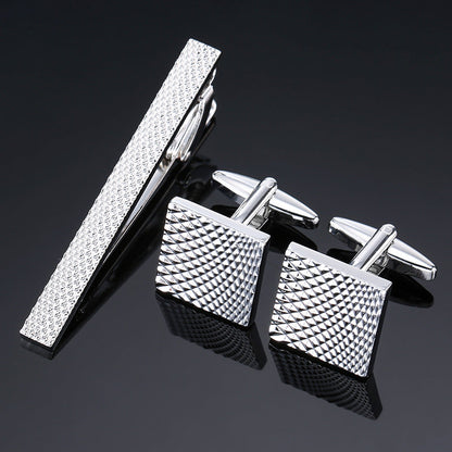 Gold and silver black crystal rose enamel flower tie clip and cuff buckle set, close-up view