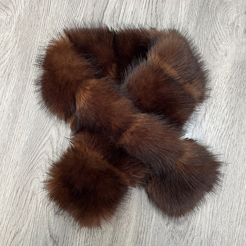 Segmented wool patches and plush materials cross-knitted into a mature, elegant coat with fur accents