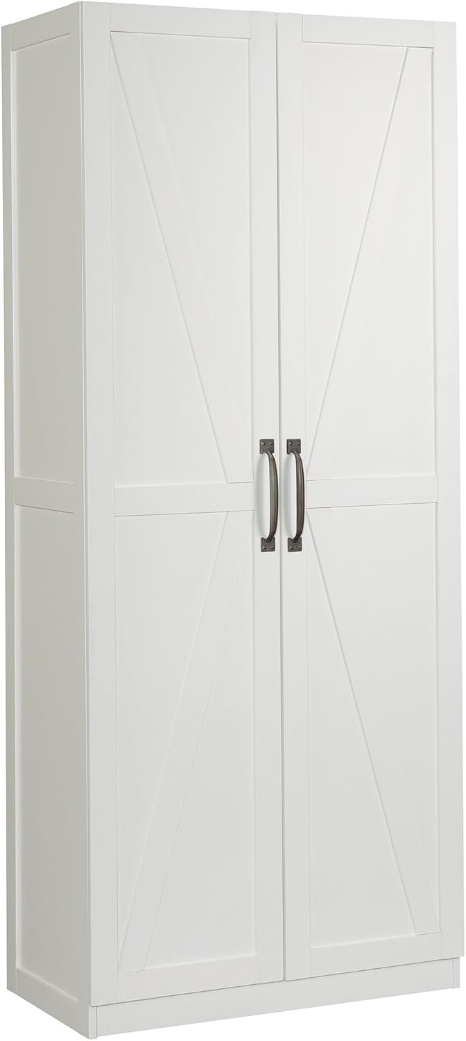 Sauder Select white storage cabinet with pantry shelves, featuring variety snack chips on top, in a home kitchen setting.