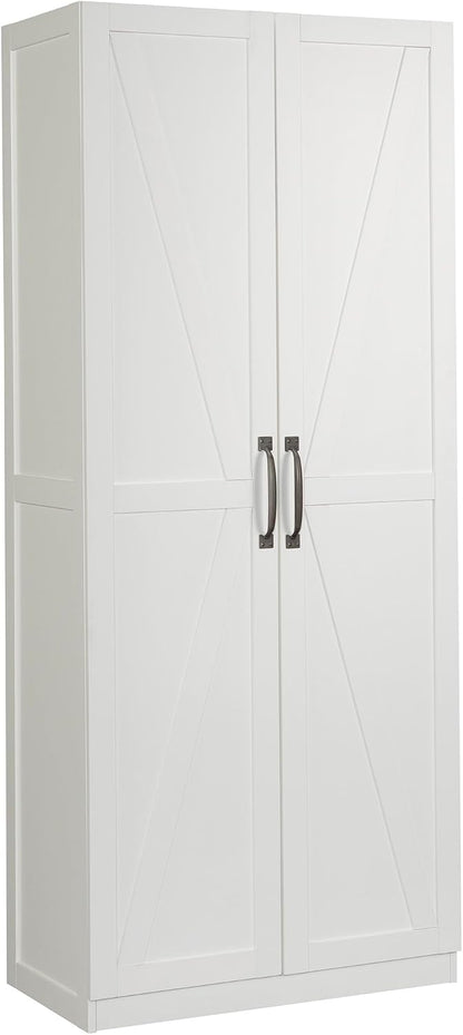 Sauder Select white storage cabinet with pantry shelves, featuring variety snack chips on top, in a home kitchen setting.