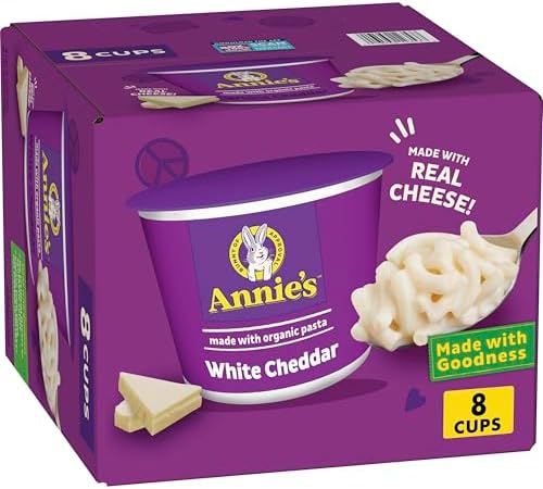 Annie's White Cheddar Mac and Cheese Microwavable Cups, 8-pack, showing the cups with cheese and pasta inside