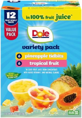 Canned Dole pineapple tidbits and tropical fruit in 4 oz bowls, 12-pack, with vibrant pineapple and mixed fruit pieces.
