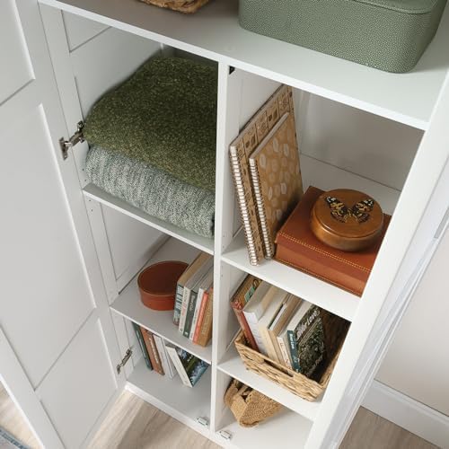 Sauder Select white storage cabinet with pantry shelves and snack chip variety inside for organized kitchen storage