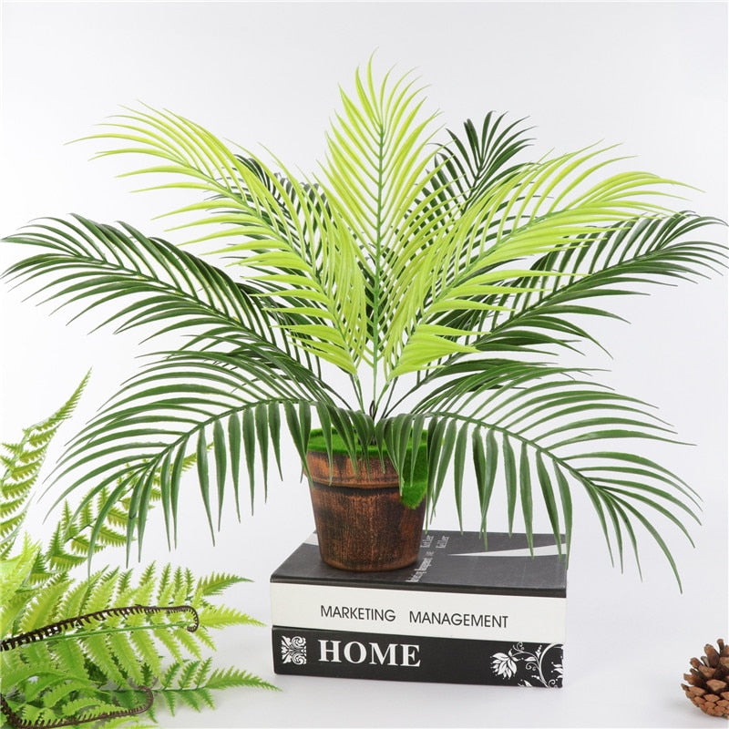 Artificial palm tree leaf plant with green simulated plastic foliage