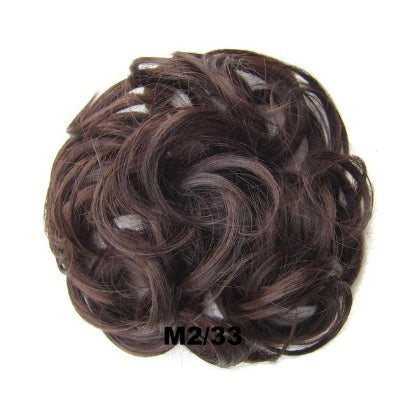 Gold hair ring accessory for styling dreadlocks and braids, close-up view