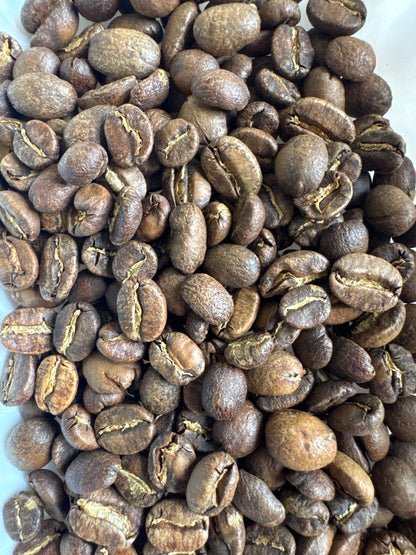 Roasted coffee bean blend with coconut cream flavor from Good Brothers Coffee LLC, showing coffee beans and coconut cream accents.