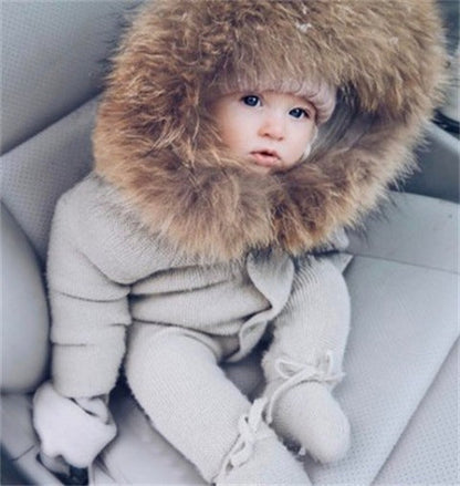 Warm hooded romper in soft fabric with long sleeves and covered feet, front view