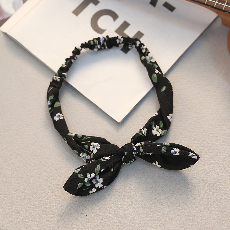Big bow tie bunny ears headband in a playful design