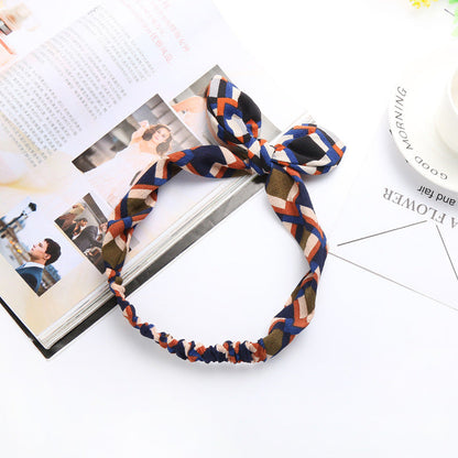 Big bow tie bunny ears headband by My Store, featuring playful upright rabbit ears and an oversized bow tie.