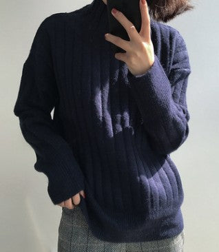 Thicker warm sweater in a cozy knit texture, front view