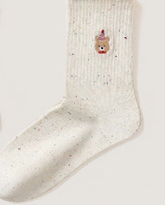Women’s embroidered ruffle-ankle socks in a close-up product view