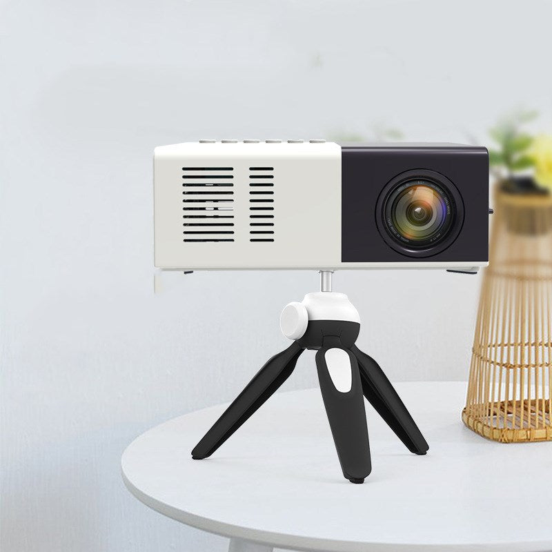 Handheld mini LED home entertainment projector for gifts, compact design with lens and control buttons
