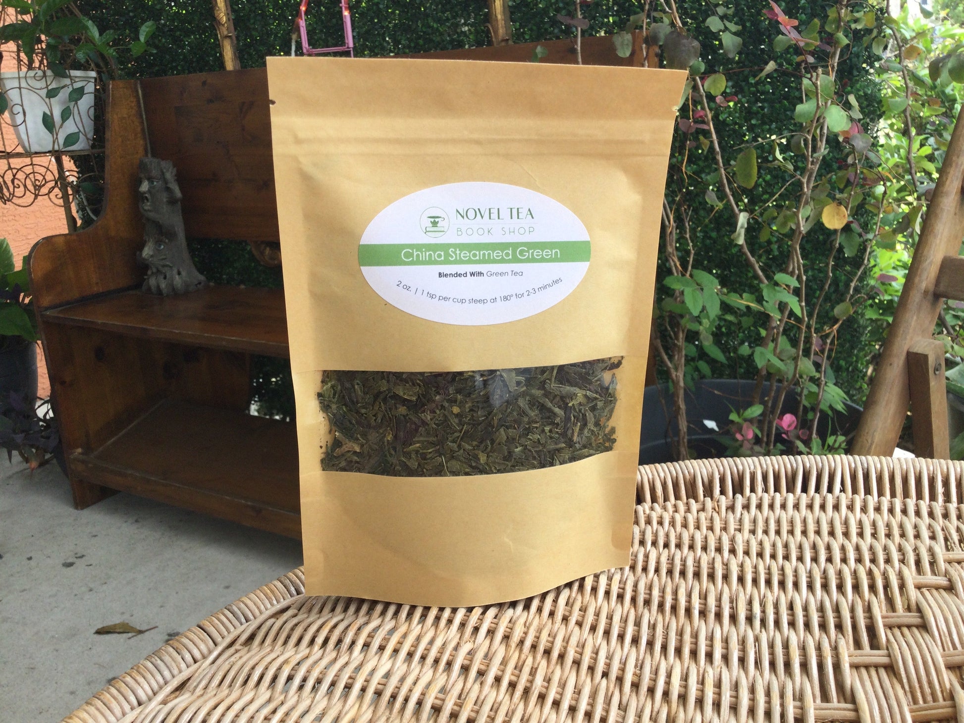 Loose leaf green tea from China in a transparent container, showcasing vibrant green tea leaves for brewing.