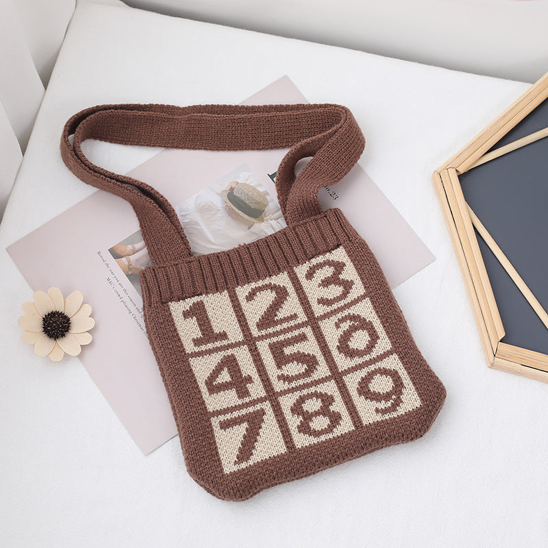 Concave shape diagonal straddle knitted bag in a textured knit design