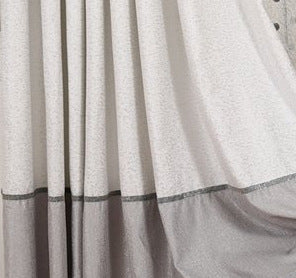 Simple blackout curtains in a solid design, shown hanging to block light