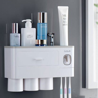 Non-marking hanging magnetic toothbrush holder with single drawer, toothpaste squeezer, and toiletry storage rack