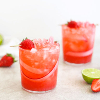 Bottle of Wood Stove Kitchen strawberry and basil cocktail and mocktail mixer, 16 fl oz, with fresh strawberries and basil in the image